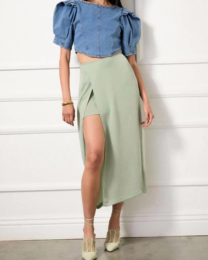 Front of a model wearing a size LG Hestia Skirt in Sage Green in Sage Green by R.G. Kane. | dia_product_style_image_id:343618
